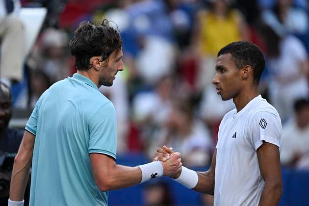 (251010) -- SHANGHAI, Oct. 10, 2025 -- Arthur Rinderknech (L) of France shakes hands with Felix Auger-Aliassime of Canada after the men s singles quarterfinal at the ATP, Tennis Herren World Tour Shanghai Masters tennis tournament in Shanghai, east China, Oct. 10, 2025. ) (SP)CHINA-SHANGHAI-TENNIS-ATP TOUR-SHANGHAI MASTERS-MEN S SINGLES (CN) ChenxHaoming 
