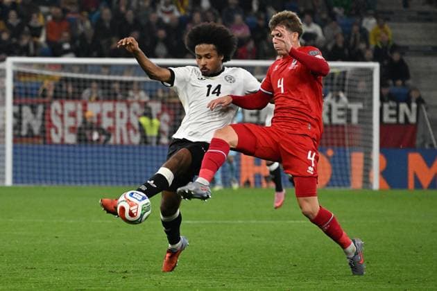 10.10.2025, xsltx, Fussball WM-Qualifikation 2026, Deutschland - Luxemburg v.l. Karim Adeyemi (Deutsche Fussball Nationalmannschaft DFB) Florian Bohnert (Luxemburg) Zweikampf, Aktion, action, battle for the ball (DFL DFB REGULATIONS PROHIBIT ANY USE OF PHOTOGRAPHS as IMAGE SEQUENCES and or QUASI-VIDEO) Sinsheim