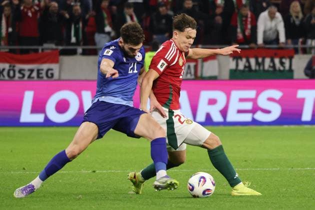 (251012) -- BUDAPEST, Oct. 12, 2025 -- Nayair Tiknizyan (L) of Armenia vies with Alex Toth of Hungary during the 2026 FIFA World Cup, WM, Weltmeisterschaft, Fussball European Qualifiers football match between Hungary and Armenia in Budapest, Hungary, on Oct. 11, 2025. (Photo by Xinhua) (SP)HUNGARY-BUDAPEST-FOOTBALL-FIFA WORLD CUP QUALIFIERS-HUNGARY VS ARMENIA AttilaxVolgyi 