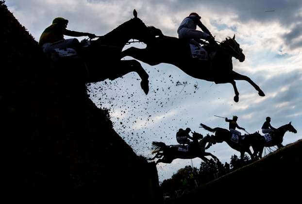 From left jockeys Jakub Kocman on Cuwall horse, Jan Kratochvil of Chlemsdorf horse and back left is Michael Donoghue on Stumptown horse crossing the Taxis ditch in 135th edition of the Grand Pardubice Steeplechase on October 12, 2025, Pardubice, Czech Republic. (CTKxPhoto RomanxVondrous) CTKPhotoP2025101204340  CTKPhotoP2025101204340