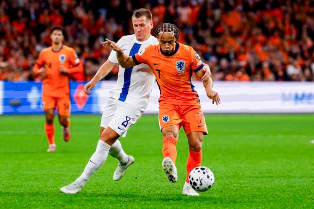 Xavi Simons of the Netherlands passes the ball under pressure from Robin Lod of Finland Netherlands v Finland, FIFA World Cup, WM, Weltmeisterschaft, Fussball 2026 Qualifier, Netherlands v Finland, Johan Cruijff Arena, October 12, 2025, Amsterdam, Netherlands.