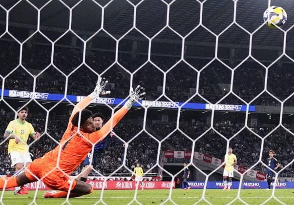 Football: Friendly between Japan and Brazil Japan s captain Takumi Minamino (background, 2nd from L) scores in the second half of an international football friendly against Brazil at Ajinomoto Stadium in Chofu, Tokyo, on Oct. 14, 2025.  A14AA0004942051P