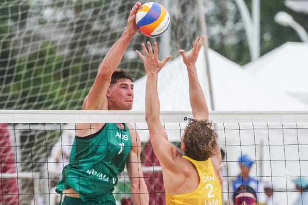 (251015) -- LAGUNA PROVINCE, Oct. 15, 2025 -- Ben Hood (L) of Australia spikes the ball against Martin Licht of Canada during the men s qualification match between Ben Hood Oliver Merritt of Australia and Luke de Greef Martin Licht of Canada at the Volleyball World Beach Pro Tour in Laguna Province, the Philippines, Oct. 15, 2025. ) (SP)THE PHILIPPINES-LAGUNA PROVINCE-VOLLEYBALL WORLD BEACH PRO TOUR ROUELLExUMALI 