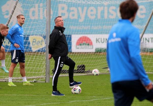 Fussball, Herren, 3.Liga, Saison 2025 2026, TSV 1860 München, Training Markus Kauczinski, Trainer (TSV 1860 München) stehend mit einem Fuss auf einem Ball und Blick nach oben, schauen. beobachten