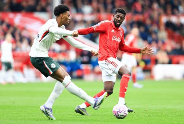 Nottingham, England, 18th October 2025. Josh Acheampong of Chelsea passes the ball whilst under pressure from Ibrahim Sangare of Nottingham Forest during the Nottingham Forest vs Chelsea Premier League match at the City Ground, Nottingham. Picture credit should read: Jessica Hornby Sportimage EDITORIAL USE ONLY. No use with unauthorised audio, video, data, fixture lists, club league logos or live services. Online in-match use limited to 120 images, no video emulation. No use in betting, games or single club league player publications. SPI_022_JH_Forest_Chelsea SPI-4217-0022