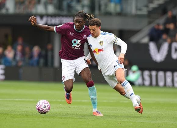 Burnley, England, 18th October 2025. Lesley Ugochukwu (L) of Burnley in action with Ethan Ampadu of Leeds United during the Burnley vs Leeds United Premier League match at Turf Moor, Burnley. Picture credit should read: Nigel Roddis Sportimage EDITORIAL USE ONLY. No use with unauthorised audio, video, data, fixture lists, club league logos or live services. Online in-match use limited to 120 images, no video emulation. No use in betting, games or single club league player publications. SPI_002_NR_BURN_LEED SPI-4219-0002