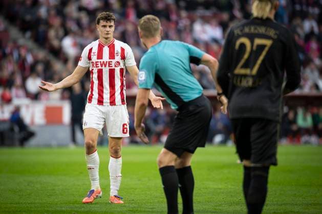1. FC Koeln vs. FC Augsburg, 18.10.2025 KOELN, GERMANY - OCTOBER 18: Captain Eric Martel (1. FC Koeln, 6) is discussing the last situation with referee Timo Gerach (Landau) and he shows where the ball hit the player in the box during the Bundesliga match between 1. FC Koeln vs. FC Augsburg at the Rheinenergie-Stadion on matchday 7 of the 1. Bundesliga on October 18, 2025 in Koeln, Germany. DFL REGULATIONS PROHIBIT ANY USE OF PHOTOGRAPHS AS IMAGE SEQUENCES AND OR QUASI-VIDEO. Copyright: xBEAUTIFULxSPORTS AxelxKohringx