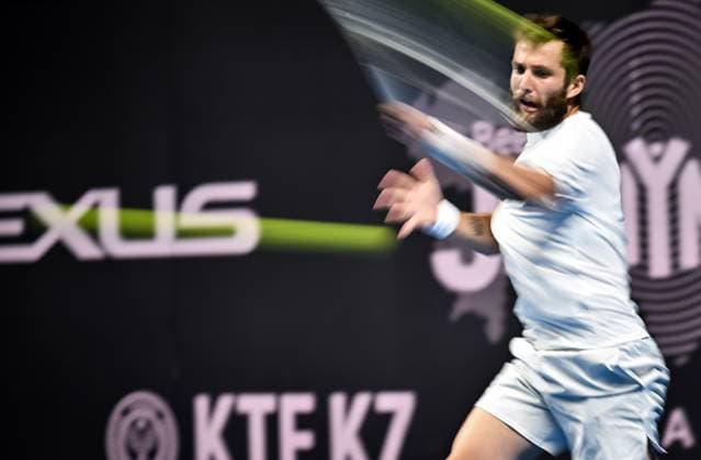(251019) -- ALMATY, Oct. 19, 2025 -- Corentin Moutet of France hits a return during the men s singles semifinal match against Alex Michelsen of the United States at the ATP, Tennis Herren 250 Almaty Tennis Open in Almaty, Kazakhstan, on Oct. 18, 2025. ) (SP)KAZAKHSTAN-ALMATY-TENNIS-ALMATY OPEN-SEMIFINAL LixRenzi 