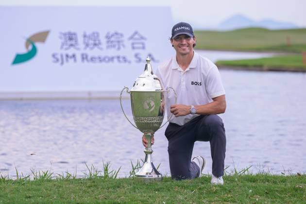 October 19, 2025, Macao, Macao Sar, China: Macau Open Golf , Final Round, Macau Golf and Country Club Coloane, Macao, China . GermanyÃ¢â‚¬â ¢s Dominic Foos Wins the Macau Open Golf after a tiebreaker with Taiwans Wang, Wei-hsuan. Foos holds the cup by the lake on the 18th fairway. Macao China - ZUMAr144 20251019_zap_r144_008 Copyright: xJaynexRussellx