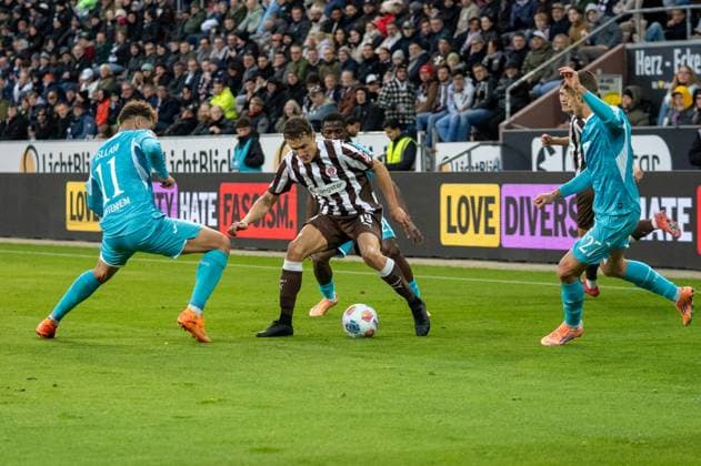 Deutschland, Fussball, 1. Bundesliga, 7. Spieltag 2025 2026, FC St. Pauli - TSG Hoffenheim am 19.10. in Hamburg (Millerntor-Stadion): Martijn Kaars (FC St. Pauli 19) im Zweikampf mit Fisnik Asllani (TSG Hoffenheim 11) und Andrej Kramaric (TSG Hoffenheim 27) Copyright: xSvenxHeidmannx