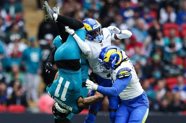 19th October 2025; Wembley Stadium, London, England; NFL, American Football Herren, USA UK Football, Los Angeles Rams versus Jacksonville Jaguars; Jacksonville Jaguars wide receiver Parker Washington gets thrown up side down during a tackle by Los Angeles Rams cornerback Emmanuel Forbes Jr.  HenningxvonxJagow