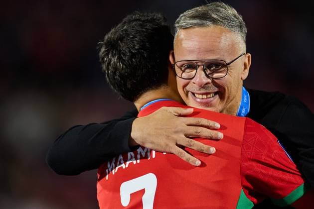 (251020) -- SANTIAGO, Oct. 20, 2025 -- Mohamed Ouahbi (R), head coach of Morocco, hugs Othmane Maamma after the final match between Argentina and Morocco at the FIFA U-20 World Cup Chile 2025 in Santiago, Chile, Oct. 19, 2025. ) (SP)CHILE-SANTIAGO-FOOTBALL-FIFA U20 WORLD CUP-FINAL MengxDingbo 