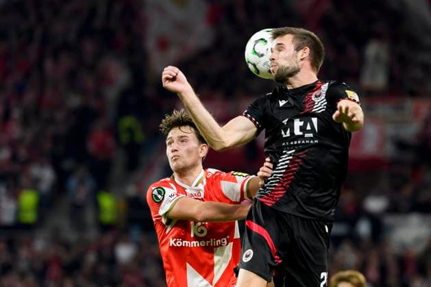 Mario Cuze (HSK Zrinjski Mostar) und Nelson Weiper (1.FSV Mainz 05) battle for the ball during the UEFA Conference League 2025 26 League Phase MD2 match between 1. FSV Mainz 05 and HSK Zrinjski Mostar at Mainz Arena on October 23, 2025 in Mainz, Germany. (Photo by Max Maiwald DeFodi Images) Mario Cuze HSK Zrinjski Mostar and Nelson Weiper 1 FSV Mainz 05 battle for the ball during the UEFA Conference League 2025 26 League Phase MD2 match between 1 FSV Mainz 05 and HSK Zrinjski Mostar at Mainz Arena on October 23, 2025 in Mainz, Germany Photo by Max Maiwald DeFodi Images