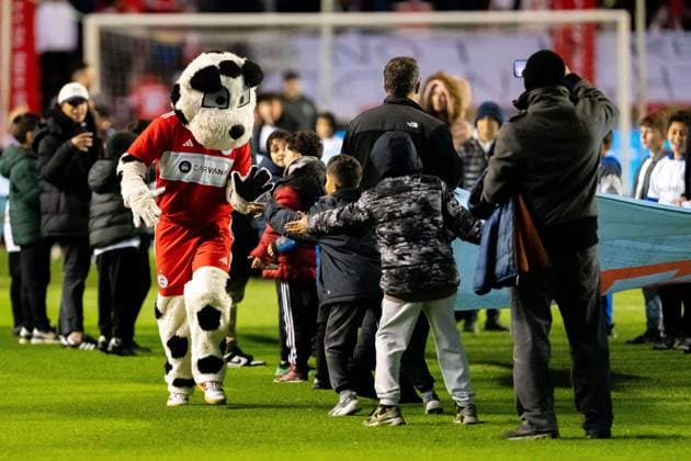 October 23, 2025, Bridgeview, Illinois, United States: Sparky the Chicago Fire mascot high fives young fans before the National Anthem performance before the Chicago Fire FC vs Orlando City Wildcard match at SeatGeek Stadium. Final Score: Chicago Fire 3:1 Orlando City Bridgeview United States - ZUMAs197 20251023_aaa_s197_376 Copyright: xRajxChavdax