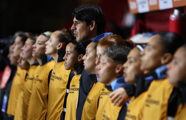 Argentina s head coach German Portanova (C) and players sing the national anthem before the CONMEBOL Women s Nations League football match, qualifier for the 2027 World Cup in Brazil, between Argentina and Paraguay, at the Diego Armando Maradona stadium in Buenos Aires, Argentina on October 24, 2025. BUENOS AIRES ARGENTINA Copyright: xALEJANDROxPAGNIx