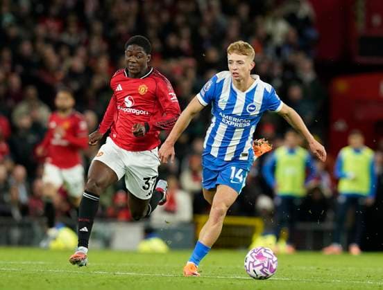 Manchester, England, 25th October 2025. Kobbie Mainoo of Manchester United, ManU chases after Tom Watson of Brighton during the Manchester United vs Brighton and Hove Albion Premier League match at Old Trafford, Manchester. Picture credit should read: Andrew Yates Sportimage EDITORIAL USE ONLY. No use with unauthorised audio, video, data, fixture lists, club league logos or live services. Online in-match use limited to 120 images, no video emulation. No use in betting, games or single club league player publications. SPI_061_AY_Man_Utd_Brighton SPI-4237-0060