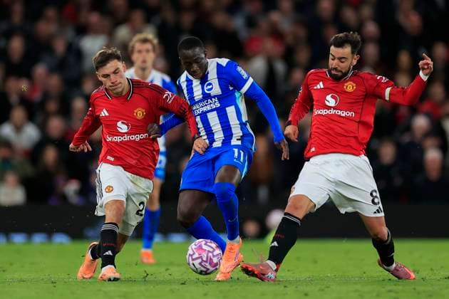 Manchester United, ManU v Brighton and Hove Albion Premier League 25 10 2025. Yankuba Minteh (11) of Brighton & Hove Albion is challenged by Bruno Fernandes (8) and Manuel Ugarte (25) of Manchester United during the Premier League match between Manchester United and Brighton and Hove Albion at Old Trafford, Manchester, England on 25 October 2025. Manchester Old Trafford Greater Manchester England Editorial use only DataCo restrictions apply See www.football-dataco.com , Copyright: xConorxMolloyx PSI-23095-0070