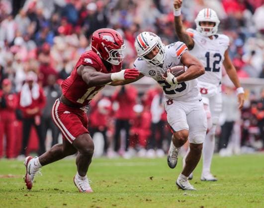 October 25, 2025, Fayetteville, Arkansas, USA: Auburn Tiger running back JEREMIAH COBB (23) gives a stiff arm to Arkansas Razorbacks linebacker STEPHEN DIX JR. (14) during Auburn s win over Arkansas at Donald W. Reynolds Razorback Stadium. Fayetteville USA - ZUMAs199 20251025_znp_s199_045 Copyright: xBrentxSoulex