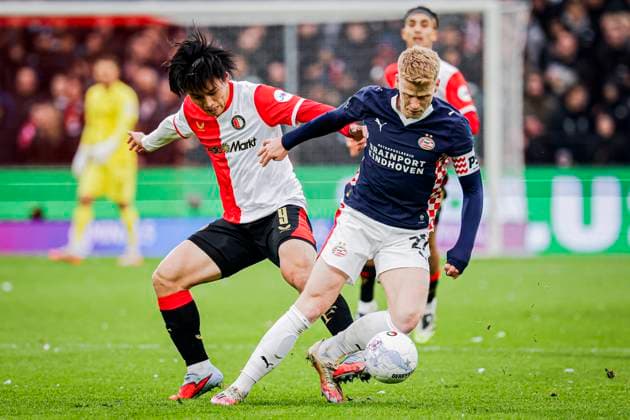 Jerdy Schouten of PSV Eindhoven battles for possession with Ayase Ueda of Feyenoord Rotterdam Feyenoord Rotterdam v PSV Eindhoven, Eredivisie, Feyenoord Rotterdam v PSV Eindhoven, De Kuip, October 26, 2025, Rotterdam, Netherlands.