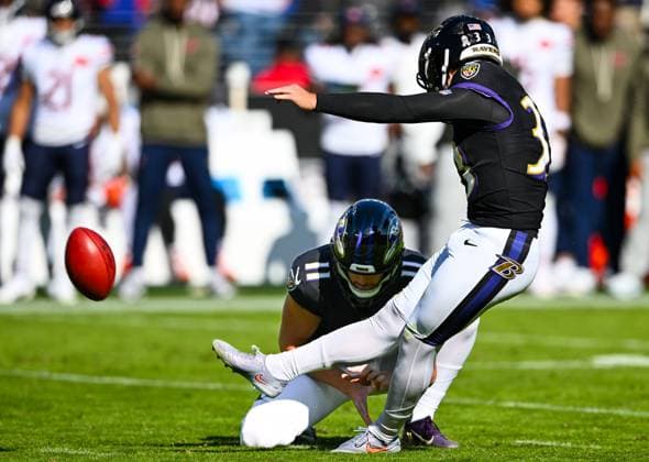 Baltimore Ravens place kicker Tyler Loop (33) kicks a 42 yard field goal against the Chicago Bears with help from holder Jordan Stout (11) during the second quarter at M&T Bank Stadium in Baltimore, Maryland, on Sunday, October 26, 2025.  BAL20251026109 DAVIDxTULIS