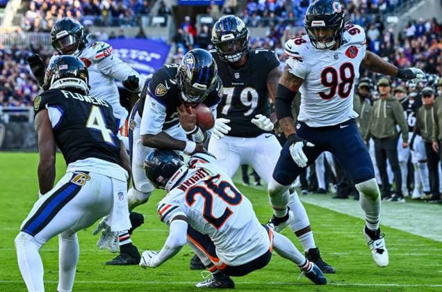 Baltimore Ravens backup quarterback Tyler Huntley (5) runs a keeper play for short yardage against the Chicago Bears during the fourth quarter at M&T Bank Stadium in Baltimore, Maryland, on Sunday, October 26, 2025. The Ravens won 30-16.  BAL20251026119 DAVIDxTULIS