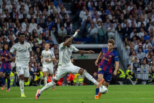 October 26, 2025, Madrid, Spain: Eder Militao (L) of Real Madrid challenges Fermin Lopez Marin (R) of FC Barcelona, Barca for a ball EA SPORTS La Liga 2025-2026 match between Real Madrid and FC Barcelona, ??played at the Santiago BernabÃ u Stadium. .Final score: Real Madrid 2 - 1 FC Barcelona Madrid Spain - ZUMAs197 20251026_aaa_s197_313 Copyright: xDavidxCanalesx