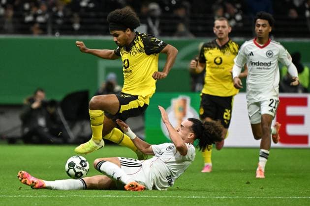 (251029) -- FRANKFURT, Oct. 29, 2025 -- Arthur Theate (bottom, front) of Eintracht Frankfurt vies with Karim Adeyemi (up, front) of Borussia Dortmund during the German Cup football second round match between Eintracht Frankfurt and Borussia Dortmund in Frankfurt, Germany, Oct. 28, 2025. (Photo by Xinhua) (SP)GERMANY-FRANKFURT-FOOTBALL-GERMAN CUP-FRANKFURT VS DORTMUND UlrichxHufnagel 