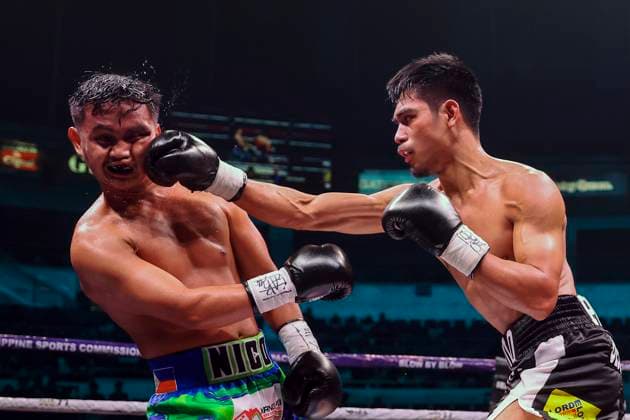 (251029) -- QUEZON CITY, Oct. 29, 2025 -- Eman Bacosa (R) of the Philippines competes against Nico Salado of the Philippines during the lightweight match at the Thrilla in Manila: 50th Anniversary in Quezon City, the Philippines on Oct. 29, 2025. ) (SP)PHILIPPINES-QUEZON CITY-BOXING-THRILLA IN MANILA 50TH ANNIVERSARY RouellexUmali 