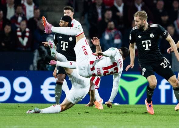 Koeln, RheinEnergieStadion, 29.10.2025: Said El Mala of Koeln falls against Konrad Laimer of Muenchen during the second round DFB Cup match between 1.FC Koeln vs. FC Bayern Muenchen.