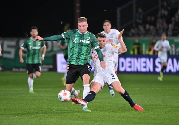Carl Johansson (Holstein Kiel), re., gegen Lars Lokotsch (Preußen Münster) 31.10.2025, Fussball 2. Bundesliga, Saison 2025 2026, 11. Spieltag, Preußen Münster - Holstein Kiel DFL regulations prohibit any use of photographs as image sequences and or quasi-video Muenster Preussenstadion Nordrhein Westfalen Deutschland