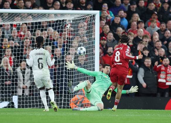 Liverpool, England, 4th November 2025. Thibaut Courtois of Real Madrid saves from Dominik Szoboszlai of Liverpool during the Liverpool vs Real Madrid UEFA Champions League match at Anfield, Liverpool. Picture credit should read: James Baylis Sportimage EDITORIAL USE ONLY. No use with unauthorised audio, video, data, fixture lists, club league logos or live services. Online in-match use limited to 120 images, no video emulation. No use in betting, games or single club league player publications. SPI_030_JB_LIVERPOOL_REAL_MADRID SPI-4264-0028