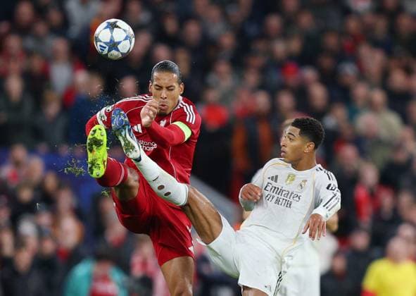 Liverpool, England, 4th November 2025. Virgil van Dijk of Liverpool tackles Jude Bellingham of Real Madrid during the Liverpool vs Real Madrid UEFA Champions League match at Anfield, Liverpool. Picture credit should read: James Baylis Sportimage EDITORIAL USE ONLY. No use with unauthorised audio, video, data, fixture lists, club league logos or live services. Online in-match use limited to 120 images, no video emulation. No use in betting, games or single club league player publications. SPI_038_JB_LIVERPOOL_REAL_MADRID SPI-4264-0033