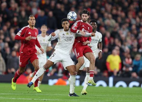 Liverpool, England, 4th November 2025. Jude Bellingham of Real Madrid and Dominik Szoboszlai of Liverpool during the Liverpool vs Real Madrid UEFA Champions League match at Anfield, Liverpool. Picture credit should read: James Baylis Sportimage EDITORIAL USE ONLY. No use with unauthorised audio, video, data, fixture lists, club league logos or live services. Online in-match use limited to 120 images, no video emulation. No use in betting, games or single club league player publications. SPI_034_JB_LIVERPOOL_REAL_MADRID SPI-4264-0036