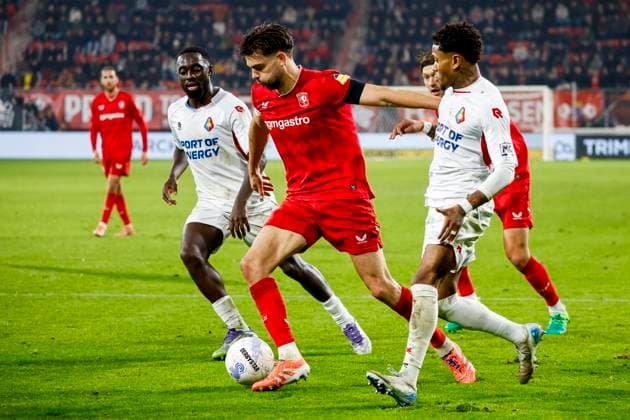 Robin Propper of FC Twente dribbles with the ball under pressure from Tyrone Owusu of Telstar FC Twente v SC Telstar, Eredivisie, FC Twente 65 v Telstar 1963, De Grolsch Veste Stadium, November 7, 2025, Enschede, Netherlands.