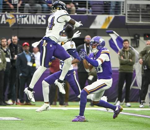 Baltimore Ravens safety Malaki Starks (L) intercepts a pass intended for Minnesota Vikings wide receiver Justin Jefferson in the second quarter against the Minnesota Vikings at U.S. Bank Stadium in Minneapolis, Minnesota on Sunday, November 9, 2025.  MIN20251109104 CRAIGxLASSIG