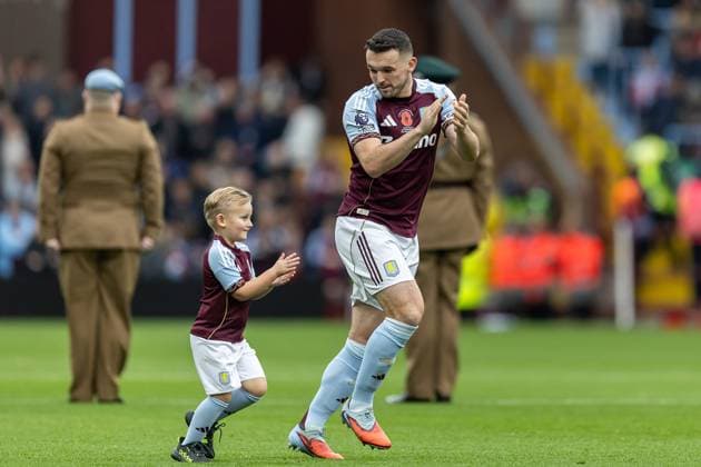 Aston Villa v Bournemouth Premier League 09 11 2025. Aston Villa midfielder John McGinn (7) encourages mascot to applaud fans before the Premier League match between Aston Villa and Bournemouth at Villa Park, Birmingham, England on 9 November 2025. Editorial use only DataCo restrictions apply See www.football-dataco.com , Copyright: xManjitxNarotrax PSI-23205-0056