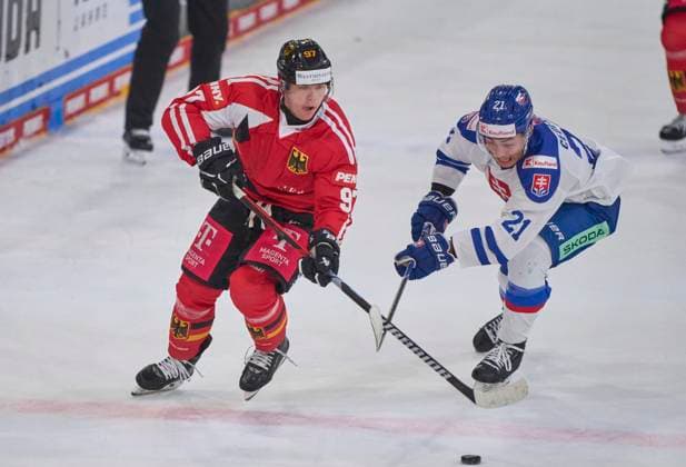 Filip Varejcka of Germany compete and fight for the puck against Sebastian Cederle of Slovakia. during the match GERMANY - SLOVAKIA 3-0 DEB Ice hockey, Eishockey DEUTSCHLAND CUP in Landshut, Germany, November 9, 2025, Season 2025 2026.