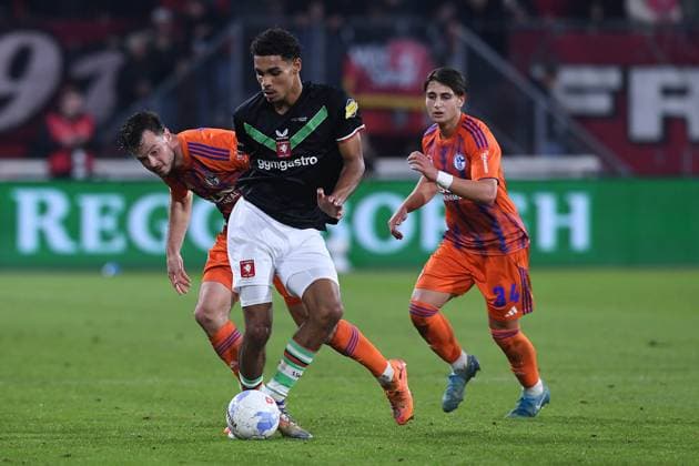 Fußball Jubiläumsspiel FC Twente Enschede - FC Schalke 04 am 13.11.2025 im Stadion De Grolsch Veste in Enschede Bjorn Titulaer ( Enschede ), vorne - Adrian Gantenbein ( Schalke ), hinten links - Janik Bachmann ( Schalke ), hinten rechts