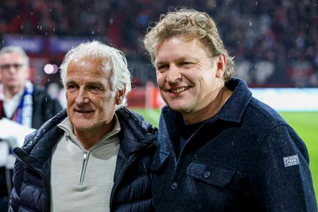 Fred Rutten of the Netherlands and technical director Youri Mulder of Schalke 04 looks on FC Twente v FC Schalke 04, 60th Anniversary Game, FC Twente v Schalke 04, De Grolsch Veste Stadium, November 13, 2025, Enschede, Netherlands.