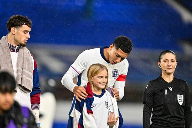 14th November 2025; St Andrews, Birmingham, Midlands, England; UEFA European Under 21 Championship Qualifying, England versus Republic of Ireland; Jobe Bellingham of England U21, U 21 gives his jacket to a mascot in the pouring rain  GodfreyxPitt