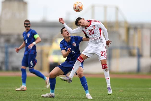 European Championships qualifiers match, Croatia U-19, Gibrltar U-19 Ivan Knezevic of Croatia and Jonathan Rowbottom compete for a ball during round 2 of European Championships 2026 qualifiers match between U19 Croatia and U19 Gibraltar at Branko Cavlovic-Cavlek Stadium on November 15, 2025 in Karlovac, Croatia.  IgorxKralj PIXSELL