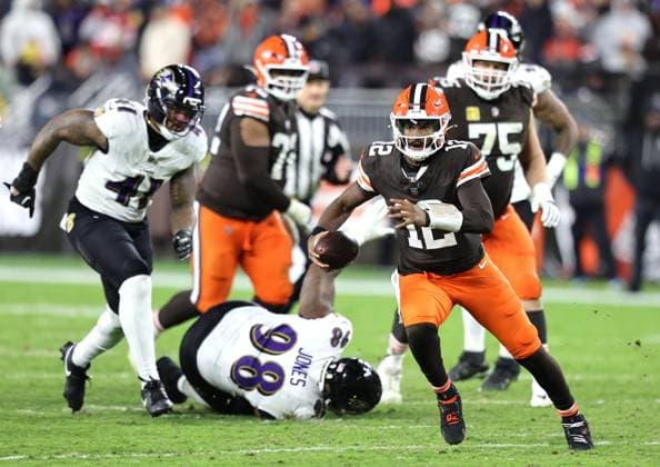 Cleveland Browns Shedeur Sanders (12) runs against the Baltimore Ravens during the fourth quarter at Huntington Bank Field in Cleveland, Ohio on Sunday, November 16, 2025.  CLE20251116125 AARONxJOSEFCZYK