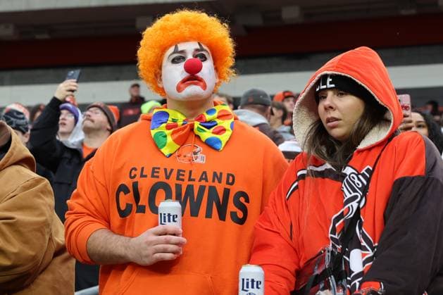 A Cleveland Browns fan dressed as a clown watches the Browns play the Baltimore Ravens at Huntington Bank Field in Cleveland, Ohio on Sunday November 16, 2025.  CLE20251116138 AARONxJOSEFCZYK
