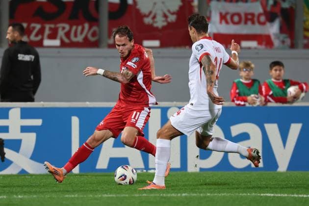 Irvin Cardona (left) of Malta is in action against Jakub Kiwior of Poland during the FIFA World Cup, WM, Weltmeisterschaft, Fussball 26 UEFA European Qualifier Group G match between Malta and Poland, at the National Stadium, in Ta Qali, Malta, 17 November 2025. FIFA World Cup 26 Qualifiers - Malta vs Poland