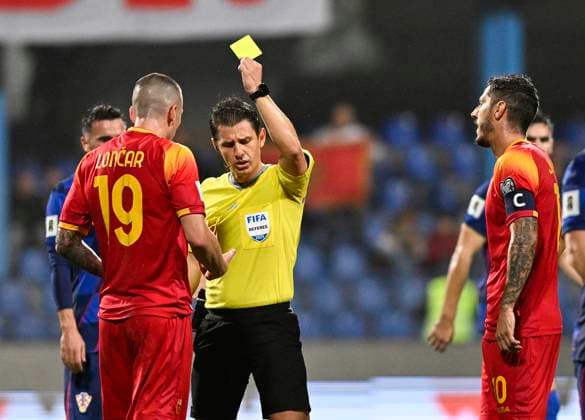 Montenegro v Croatia - FIFA World Cup, WM, Weltmeisterschaft, Fussball 2026 Qualifier PODGORICA, MONTENEGRO - NOVEMBER 17: Refree Umut Meler gives a yellow card to Stefan Loncar of Montenegro during the FIFA World Cup 2026 qualifier match between Montenegro and Croatia at Podgorica City Stadium on November 17, 2025 in Podgorica, Montenegro.  StefanxIvanovic PIXSELL