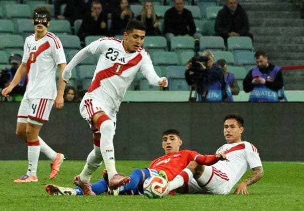 Russia Soccer Friendly Chile - Peru 9049806 18.11.2025 From left, Peru s Cesar Inga, Chile s Lautaro Millan and Peru s Jesus Pretell struggle for a ball during the friendly soccer match between Chile and Peru at the Fisht Olympic Stadium, in the Sirius Federal Territory, Krasnodar Region, Russia. Ekaterina Lyzlova Sputnik Sochi Russia  Copyright: xEkaterinaxLyzlovax