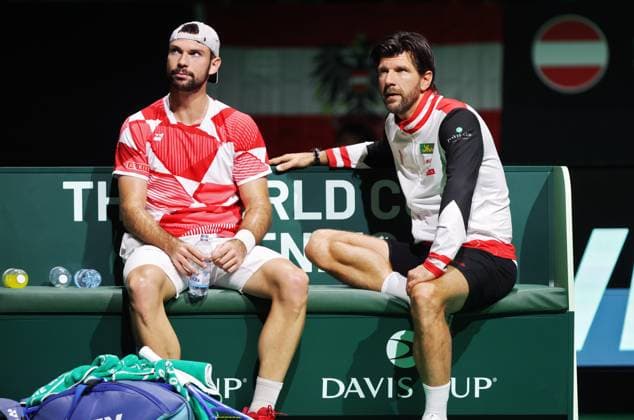 TENNIS - Davis Cup Final 8 BOLOGNA,ITALY,19.NOV.25 - TENNIS - ITF Davis Cup, Final 8, Italy vs Austria. Image shows Jurij Rodionov and captain Juergen Melzer (AUT).  GEPAxpictures xMatthiasxHauer