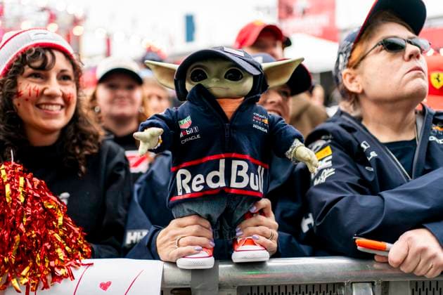 A fan holds a stuffed Baby Yoda doll dressed in Red Bull Racing gear at the fan zone during the Formula One Las Vegas Grand Prix at the Las Vegas Strip Circuit in Las Vegas on Friday, November 21, 2025.  LAS2025112107 GREGxNASH