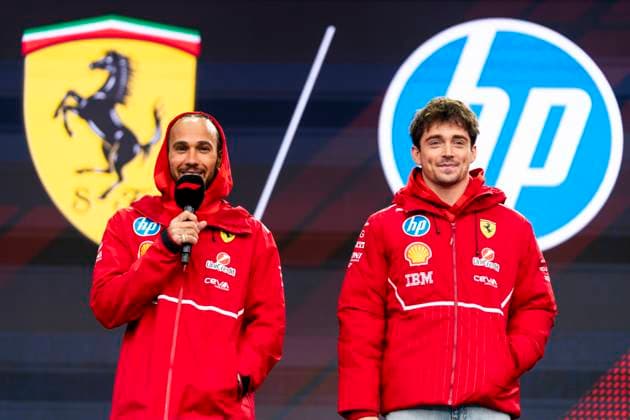 British Formula One driver Lewis Hamilton and Monaco s Formula One driver Charles Leclerc of Scuderia Ferrari appear at the fan zone during the Formula One Las Vegas Grand Prix at the Las Vegas Strip Circuit in Las Vegas on Friday, November 21, 2025.  LAS2025112113 GREGxNASH