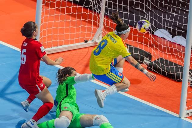 (251122) -- PASIG CITY, Nov. 22, 2025 -- Angely Camargo (R) of Colombia scores a goal against goalkeeper Lea Palacio-Tellier (C) and Shayla He (L) of Canada during the match between Colombia and Canada at the FIFA Futsal Women s World Cup 2025 in Pasig City, the Philippines, Nov. 22, 2025. ) (SP)PHILIPPINES-PASIG CITY-FUTSAL-WOMEN S WORLD CUP 2025-COLOMBIA VS CANADA RouellexUmali 